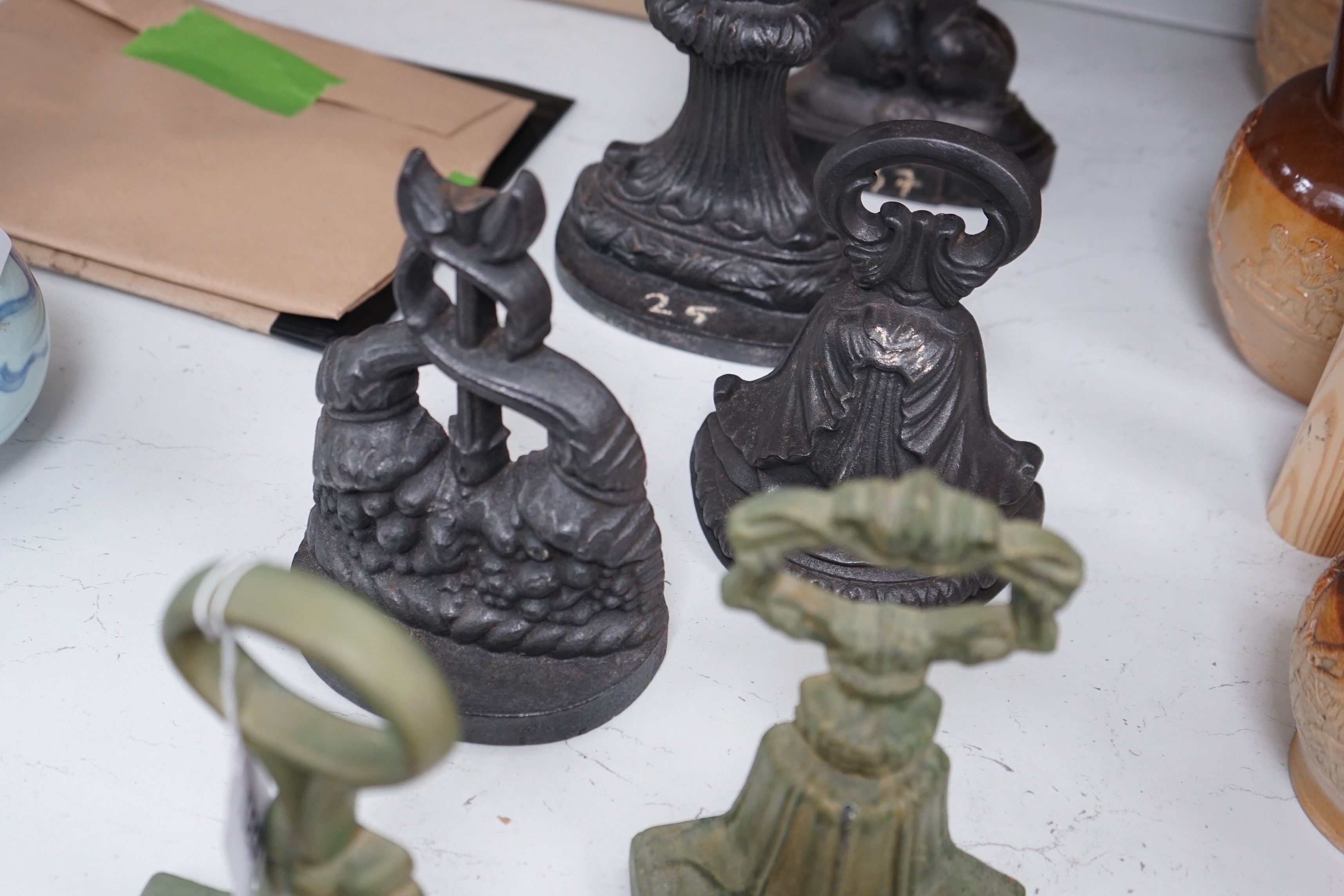 A group of six assorted cast iron Victorian door stops, two later painted, 26cm tall